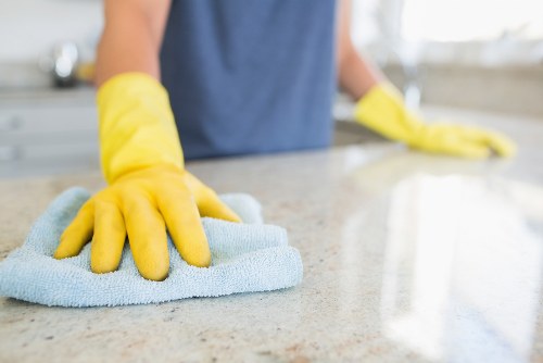 Safety-focused cleaning team member wearing PPE during detailed cleaning work